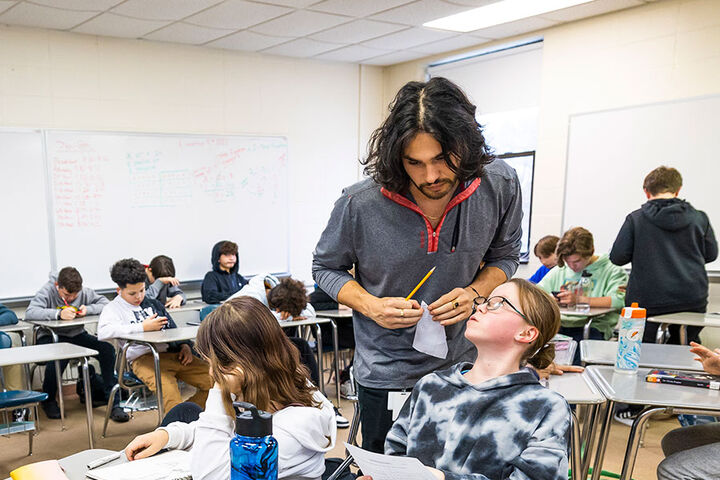 A male teacher works with elementary school students in South Bend, Indiana.